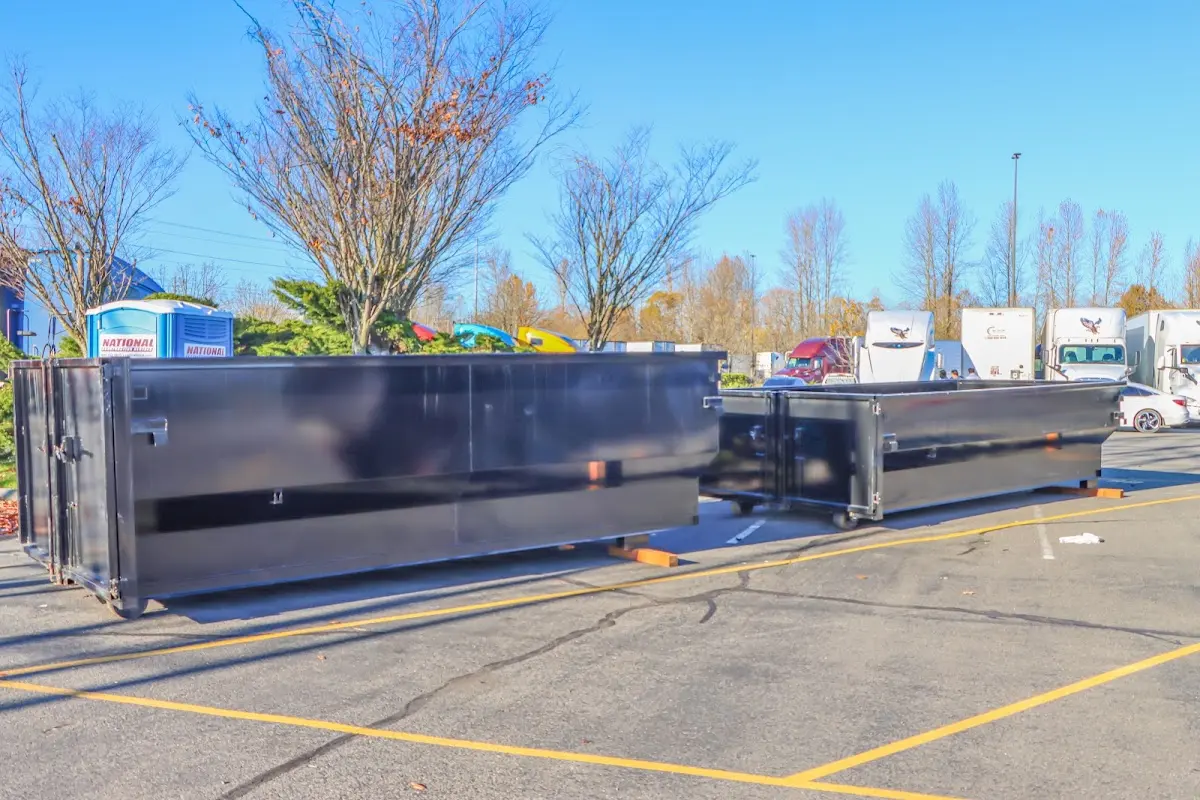 Professional dumpster rental service with roll-off container on residential driveway in Albemarle